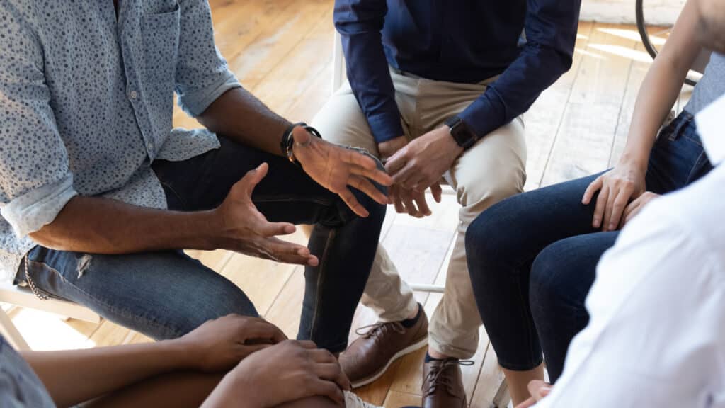 Closeup of hands during a group therapy session.