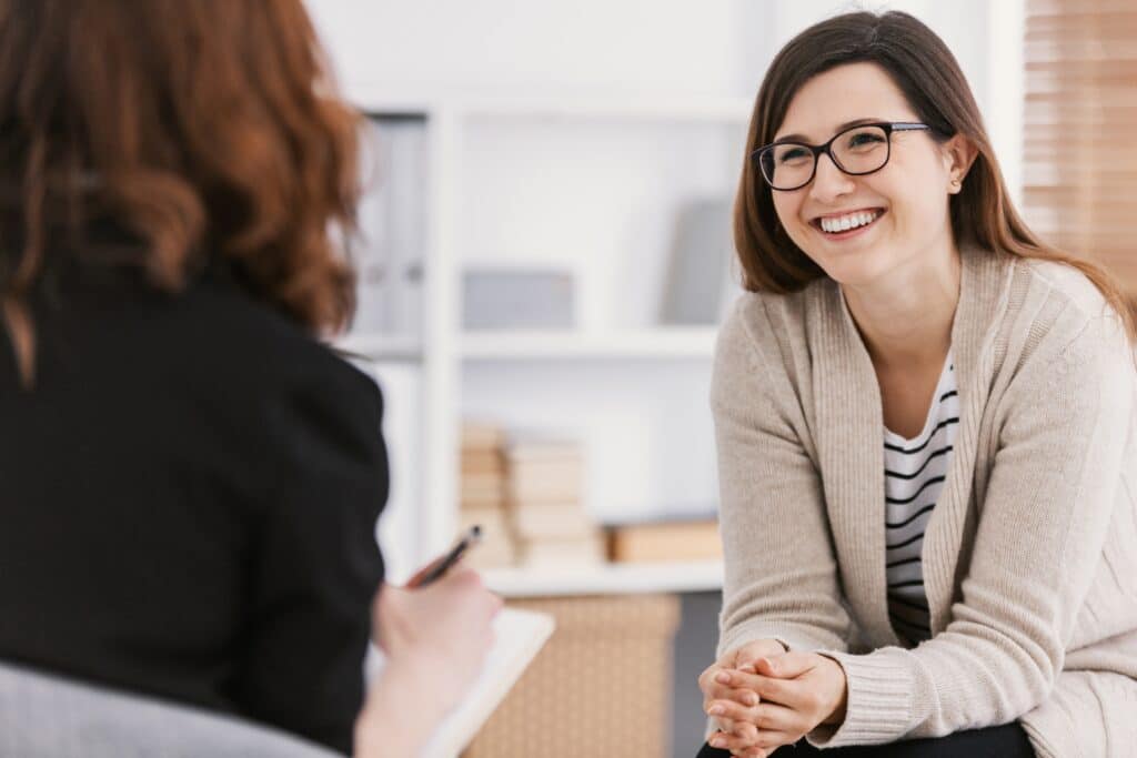 Woman smiles during a therapy session.