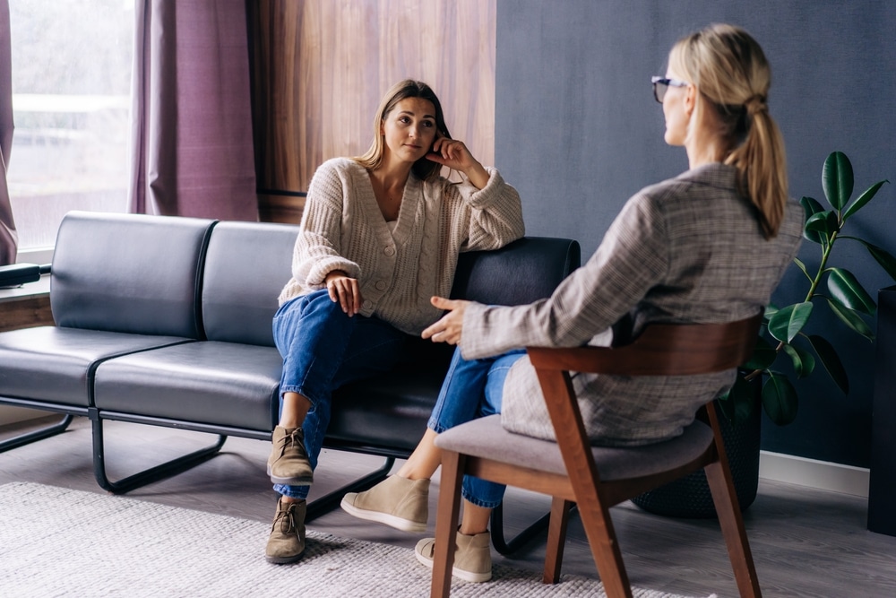 A woman talks with therapist during a therapy session.