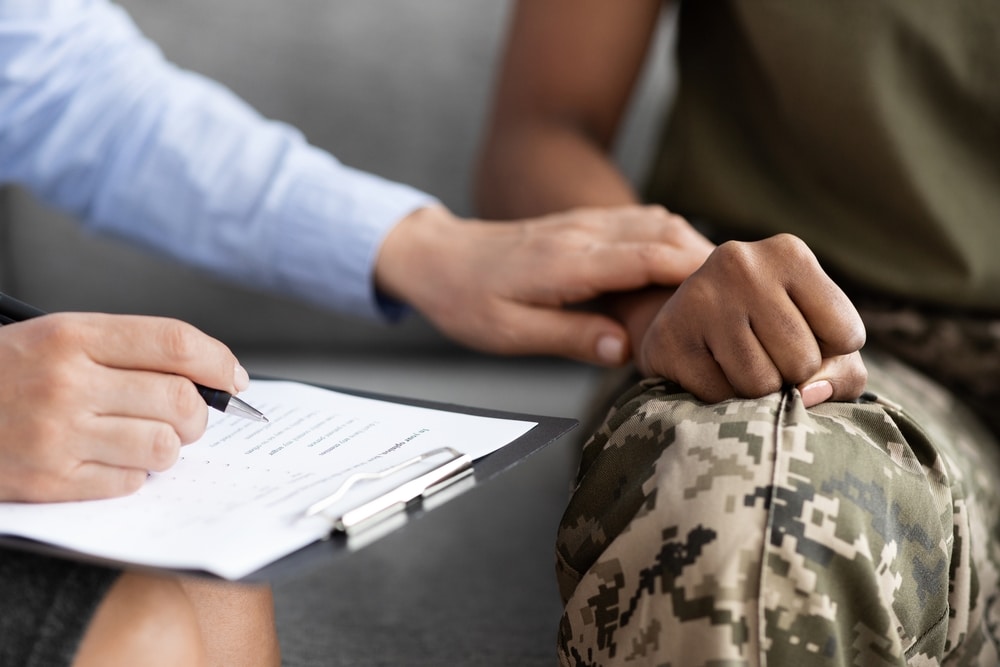 Closeup of counselor comforting a veteran.