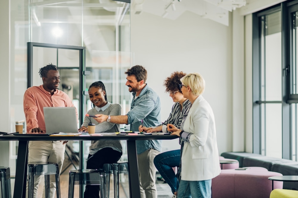 Employees gather together in the workplace.