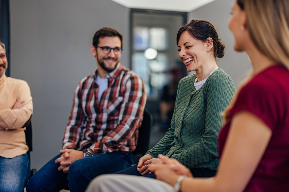 Happy woman in group therapy.