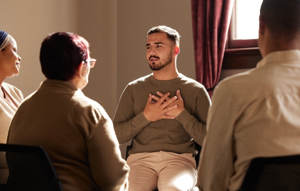 Man speaks during a therapy session.