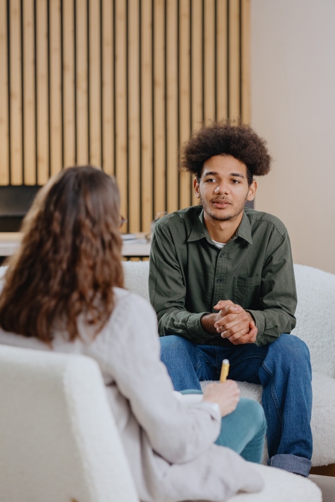 A man listens during a therapy session.