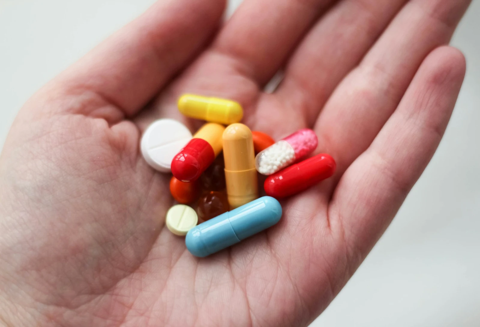 Hand with variety of pills
