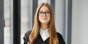 What Is A Sponsor? A woman with glasses standing facing the camera