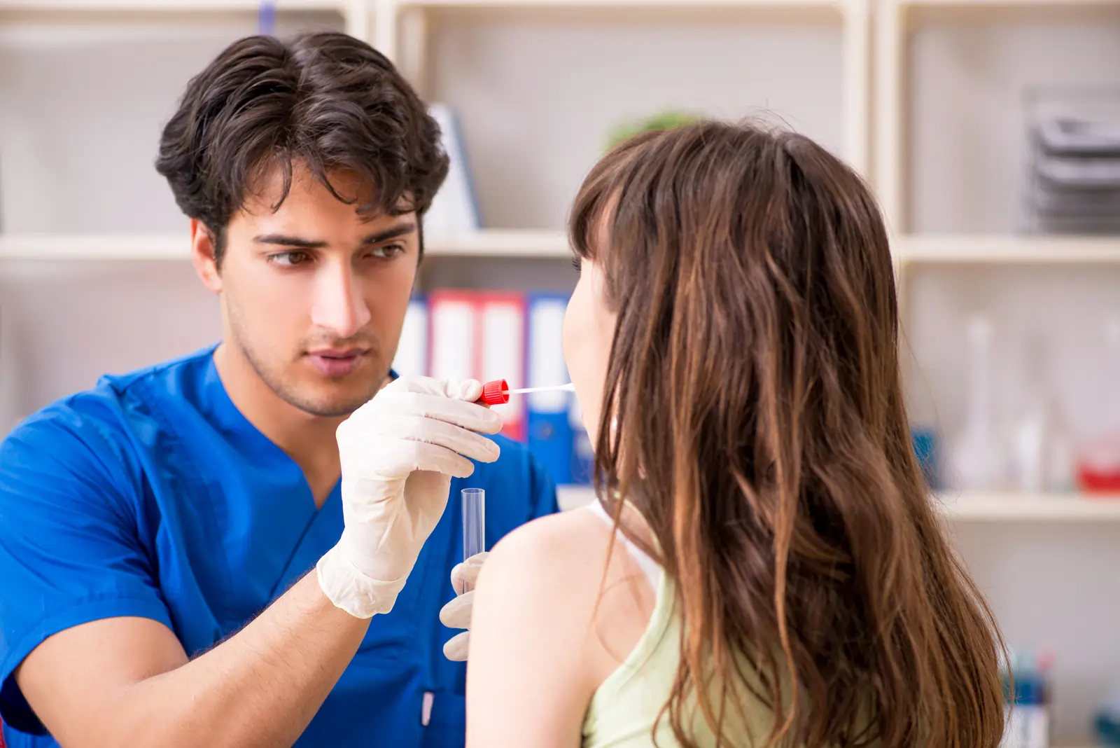 Doctor doing saliva test on patient