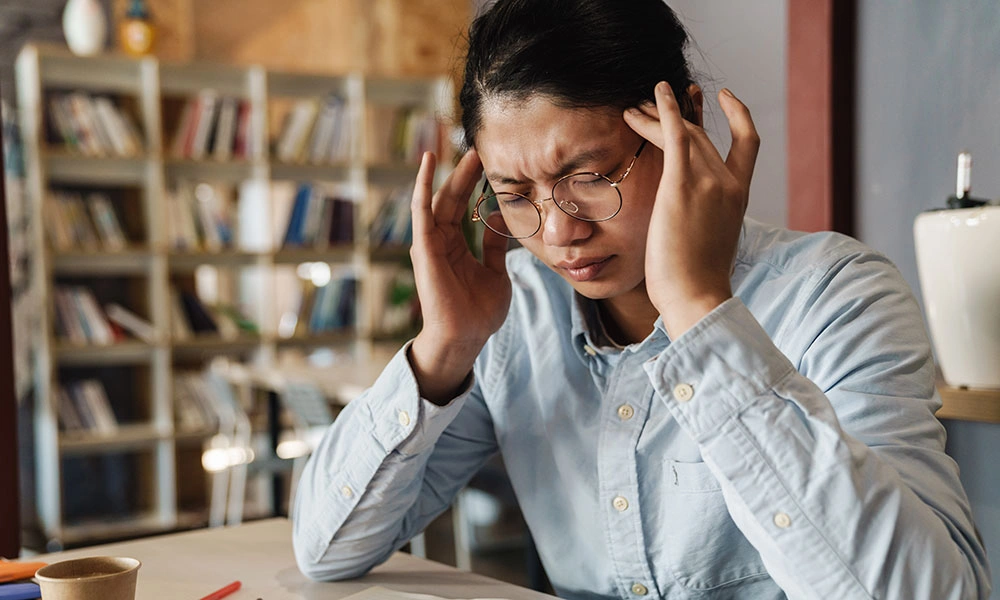 Woman struggling to concentrate due to medication side effects.